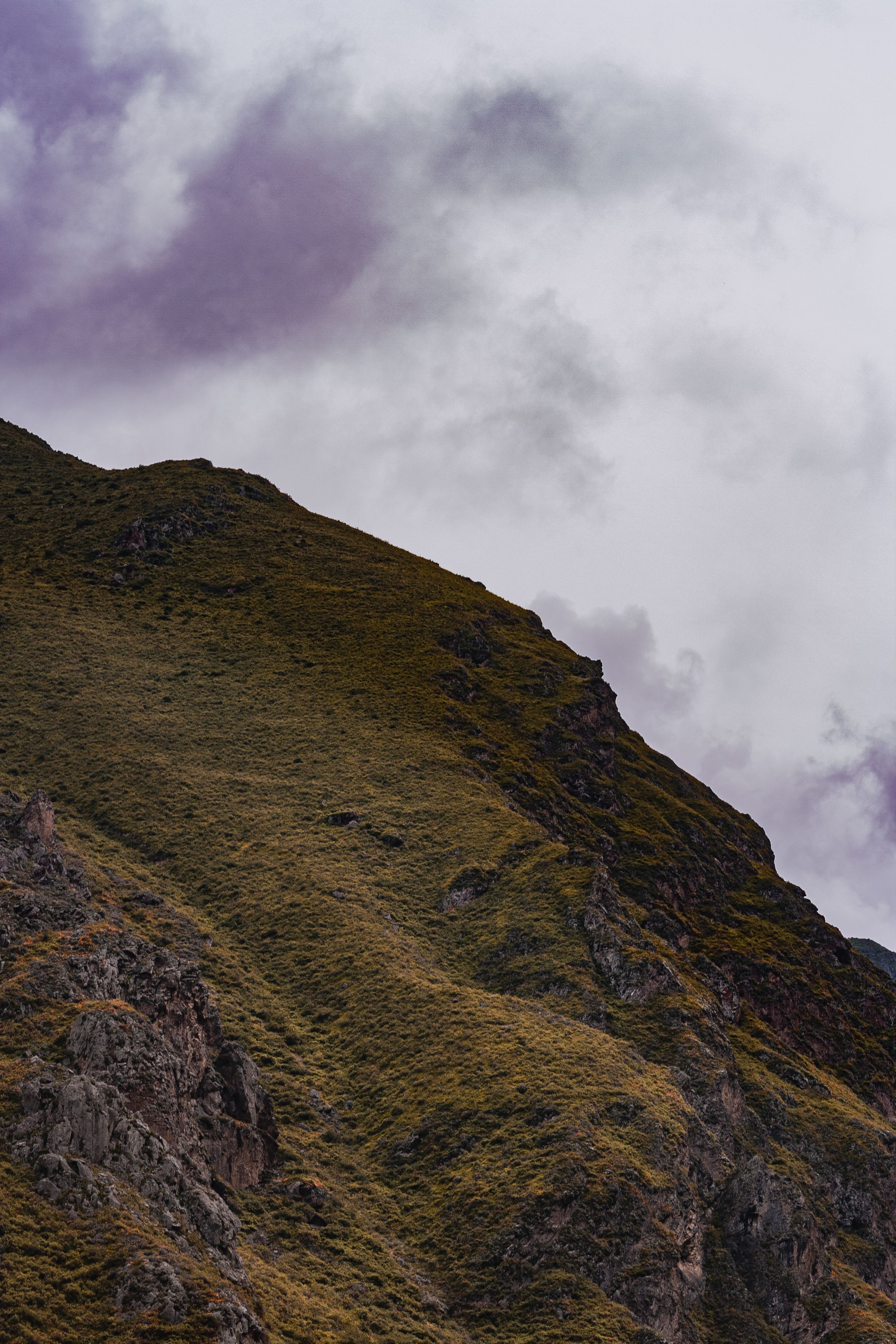 View of a Rocky Mountain under a Cloudy Sky · Free Stock Photo