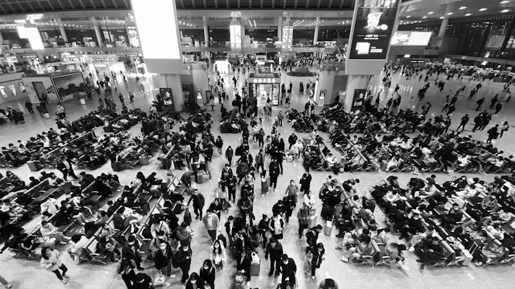 People On Airport Terminal In Black And White