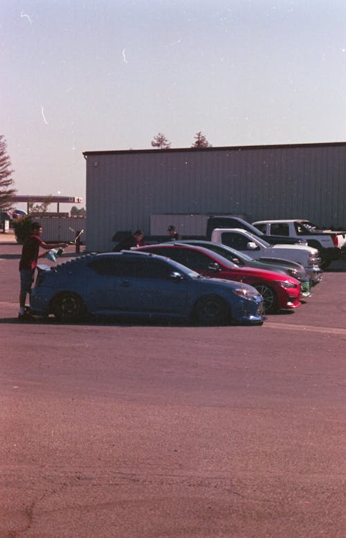 People near Sports Cars on Car Park