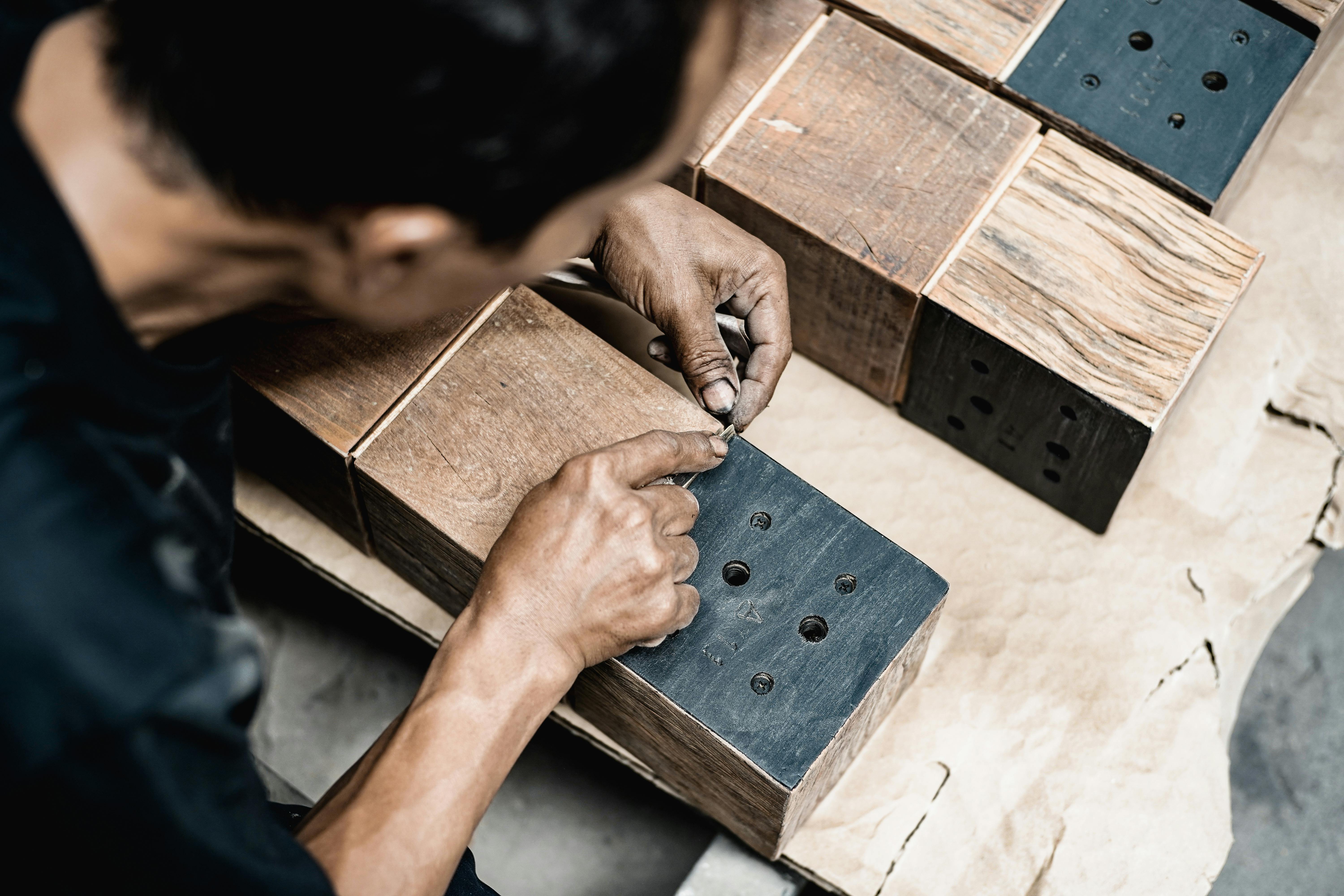 Close-Up Shot of a Carpenter Measuring a Wood Plank · Free Stock Photo