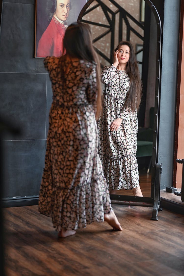 Women In Floral Dress Looking In The Mirror