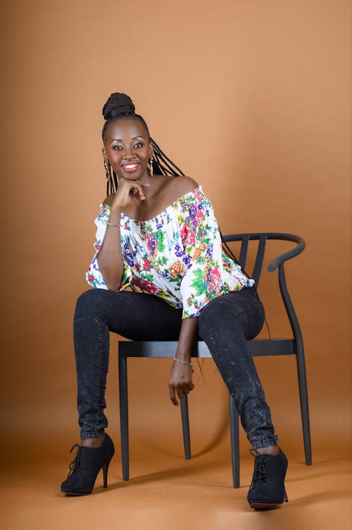 Smiling Model Posing Sitting on a Chair