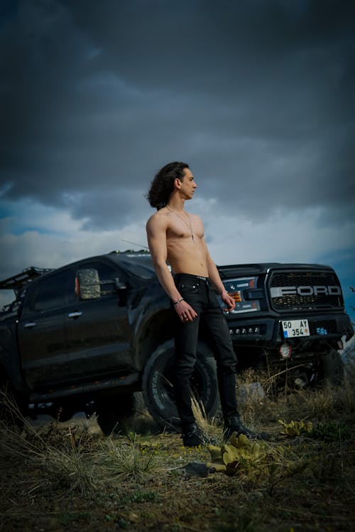 Sexy Topless Man Posing near Car on Sunset