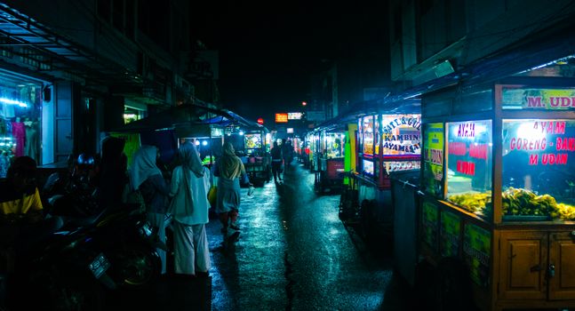 Vibrant night scene of a bustling street market in Kota Garut, Indonesia.
