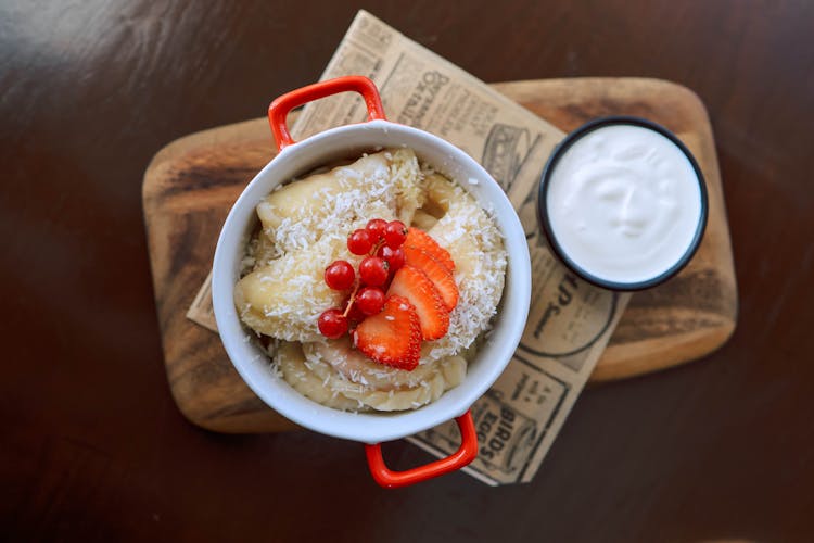 Delicious Food With Fruits And Cream On Table