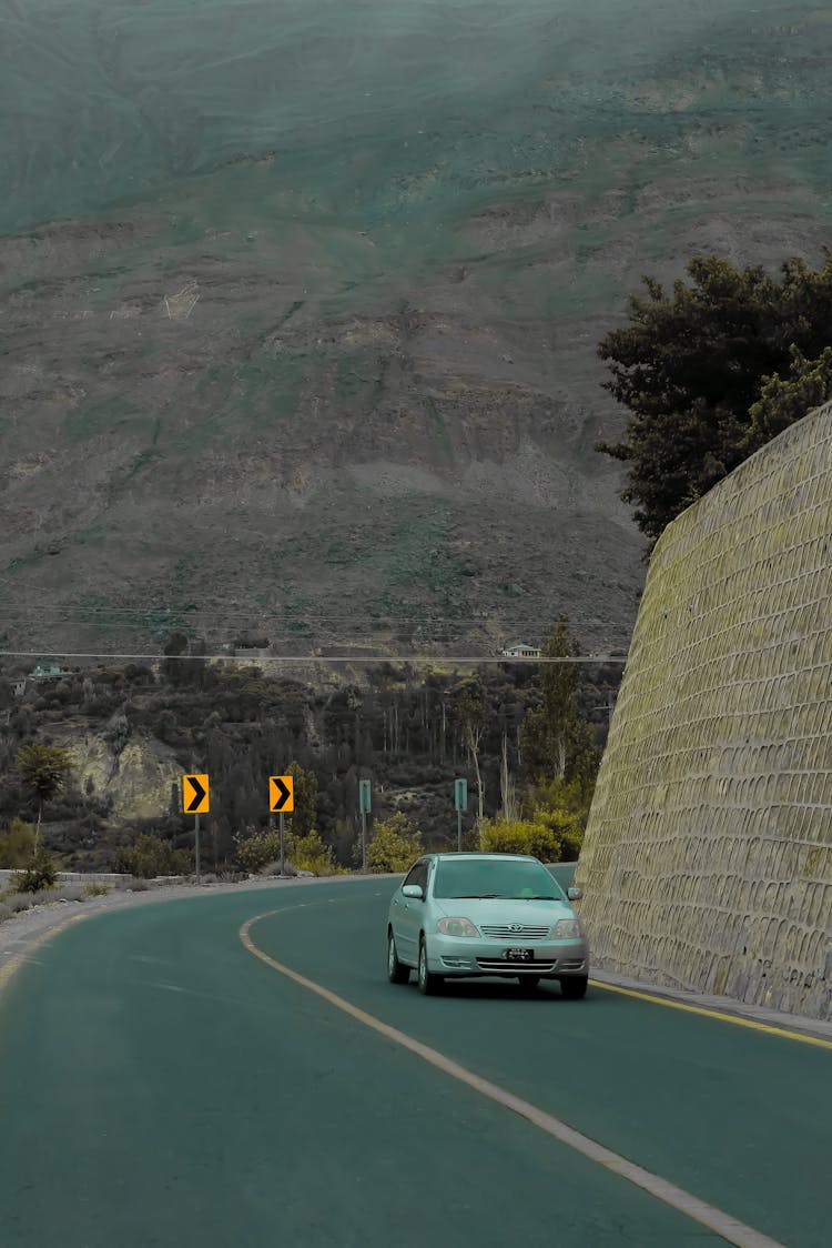 Car Driving On Road In Mountains