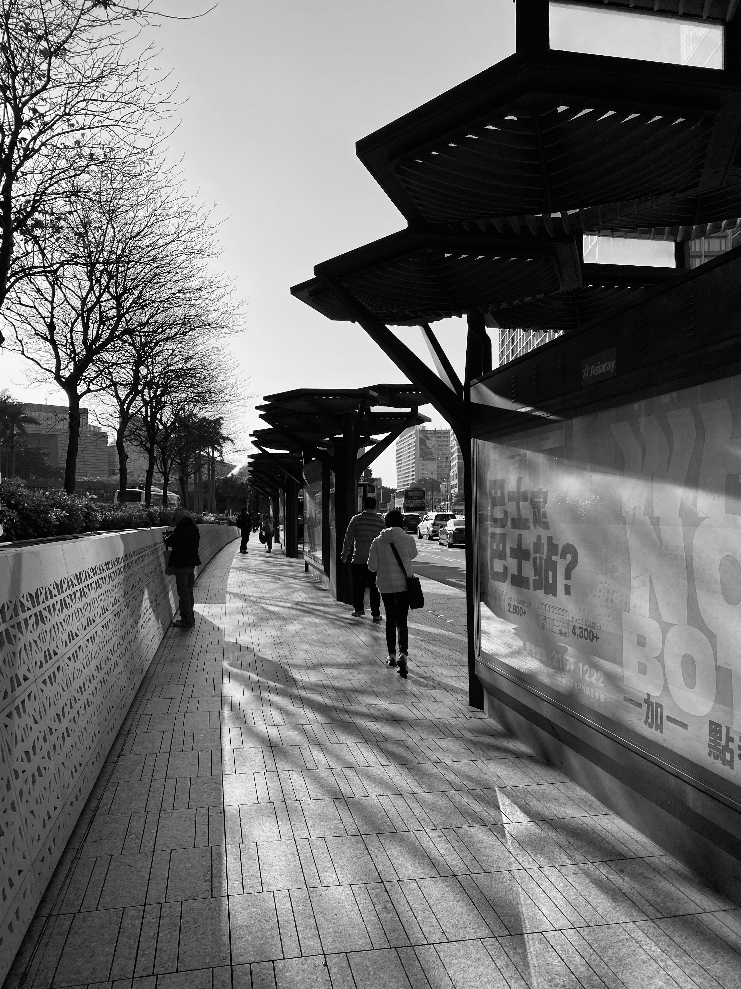 A Grayscale of People Walking on a Sidewalk · Free Stock Photo