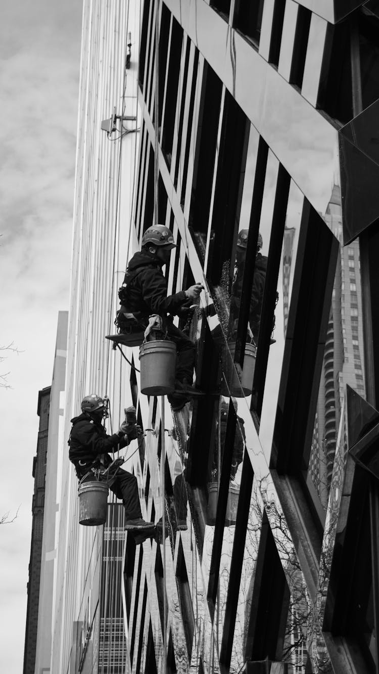 Window Washers Climbing On Glass Skyscraper