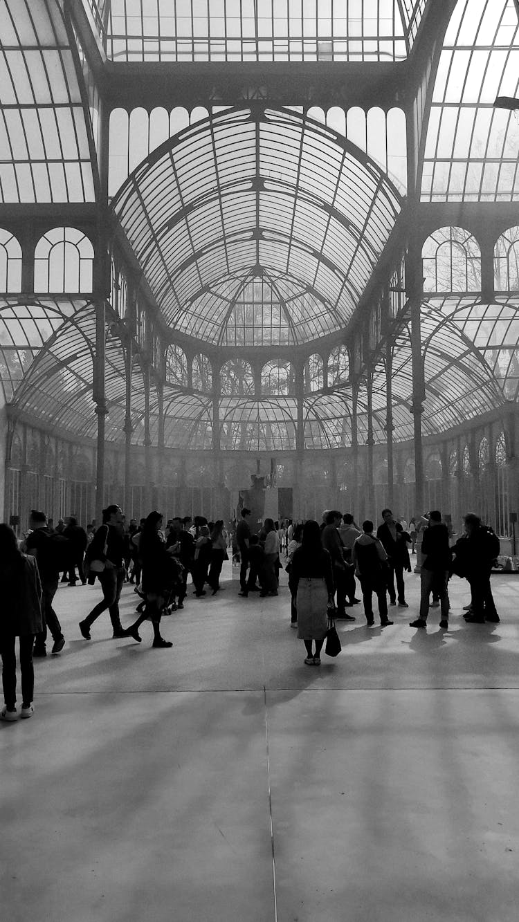 People Walking In Palace With Glass Dome Ceiling 