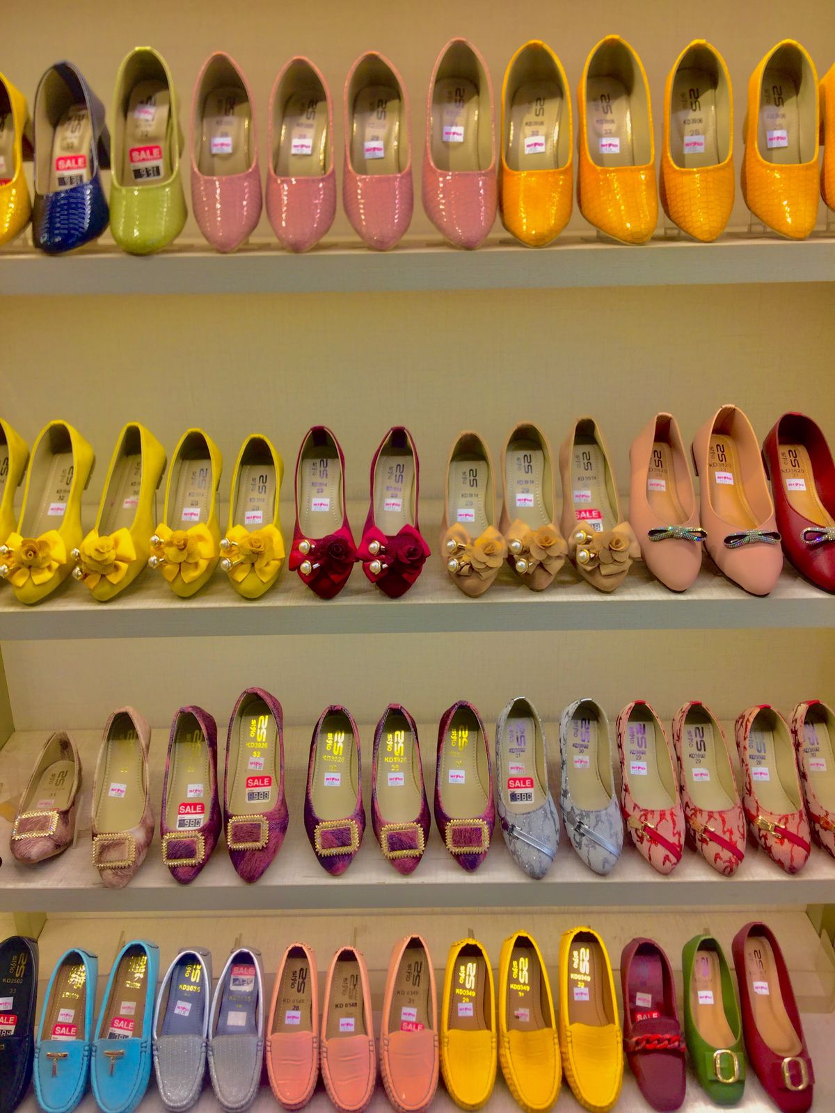 Shoes displayed on retail shop shelves with sale prices