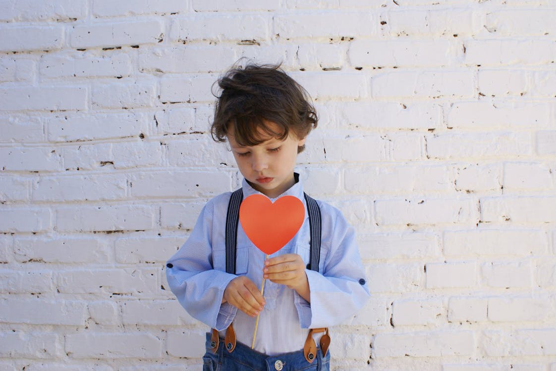 Free Photo of Boy Holding Heart-shape Paper on Stick Stock Photo