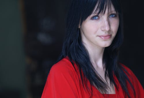 A woman with long black hair and blue eyes