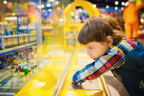 Selective Focus Photography of Toddler in Front of Glass