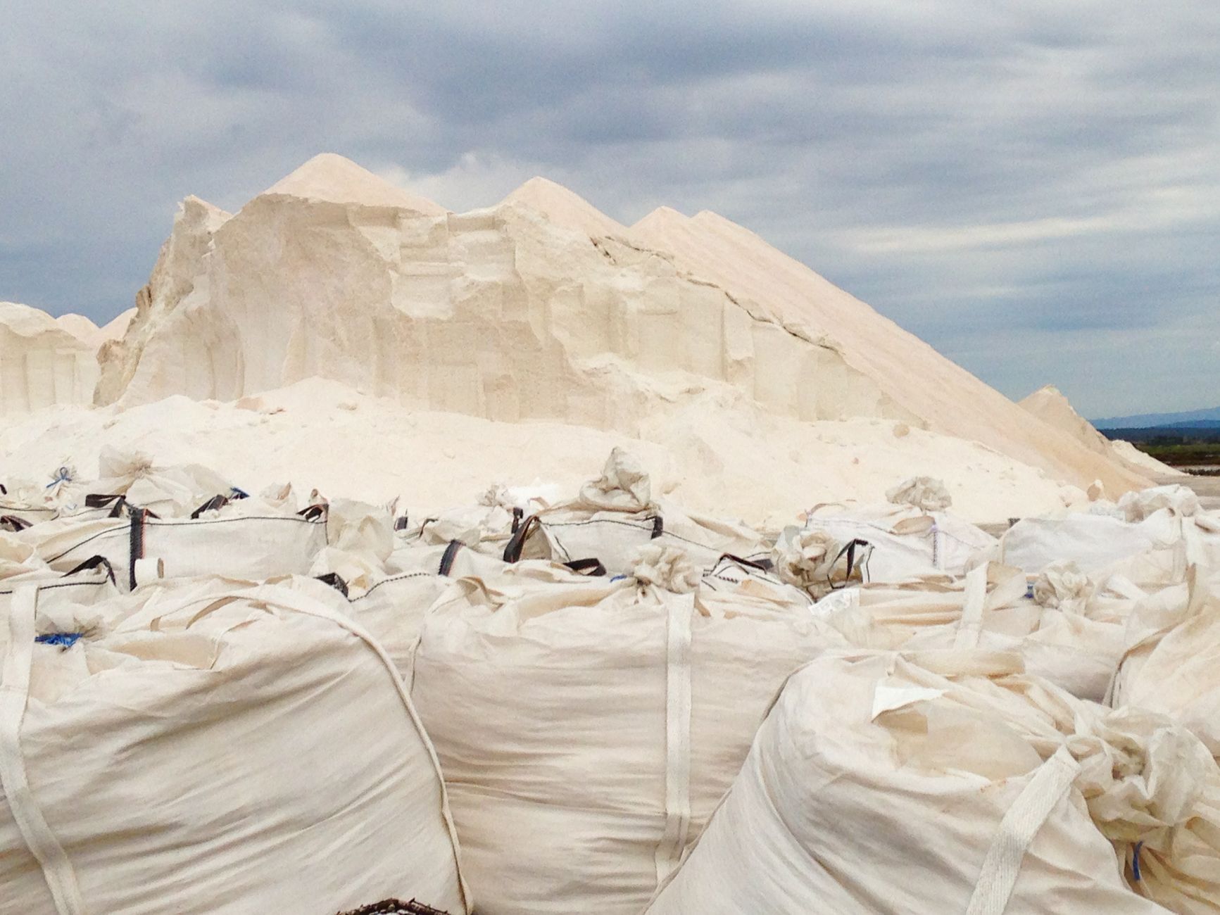 Salt bags and piles at a harvesting site in Ibiza, Spain.
