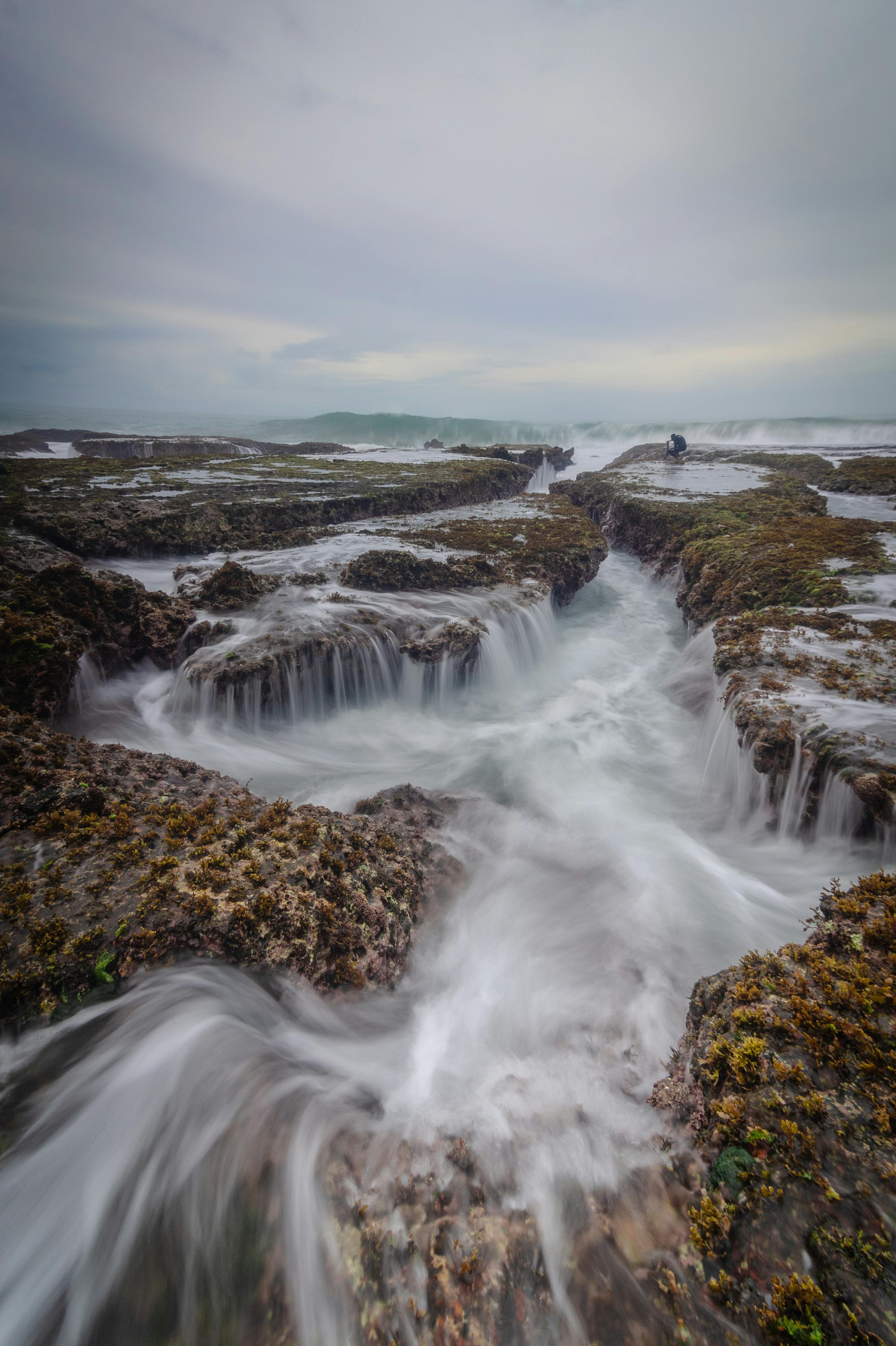 Discover the dynamic flow of water over rocky coast in Banten, Indonesia.
