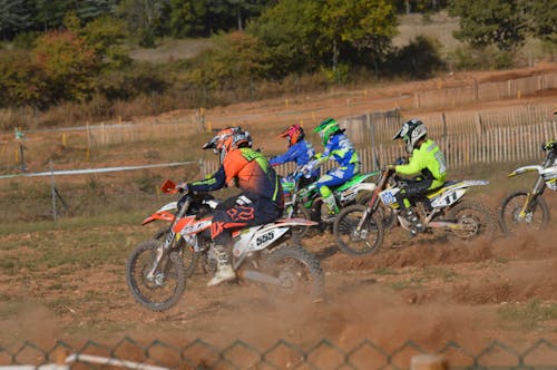 Men Riding Motocross Dirt Bikes during a Race