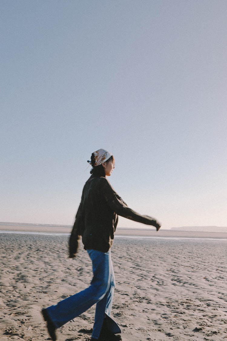 Woman Walking On The Beach 