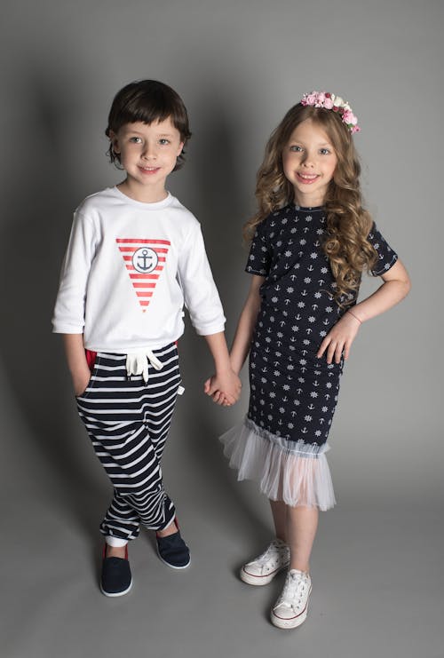 Boy and Girl Taking Photo While Holding Hands