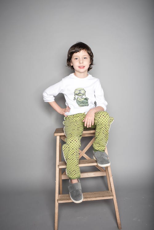 Free Boy Sitting on Beige Wooden Step Stool Stock Photo