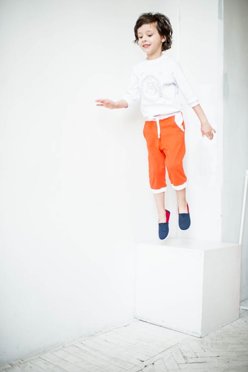 Free Boy Jumping Near Wall Stock Photo