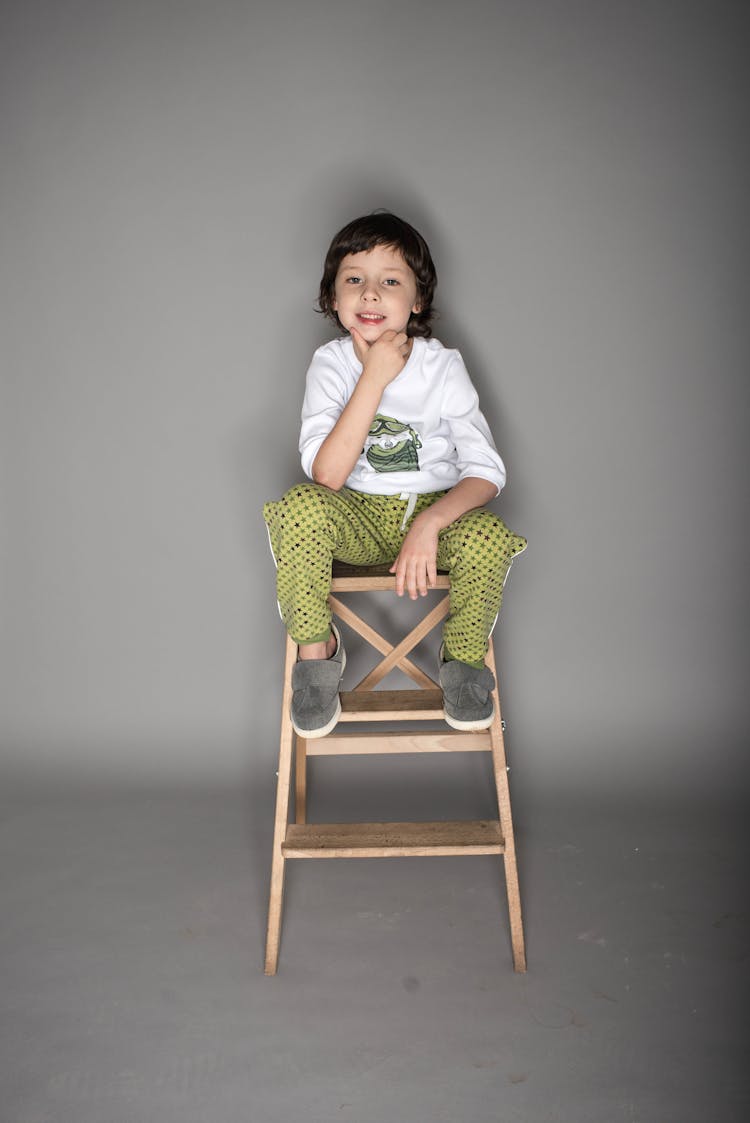 Photo Of Boy Sitting On Chair