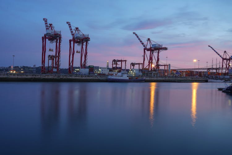 Cranes In The Port At Sunset 