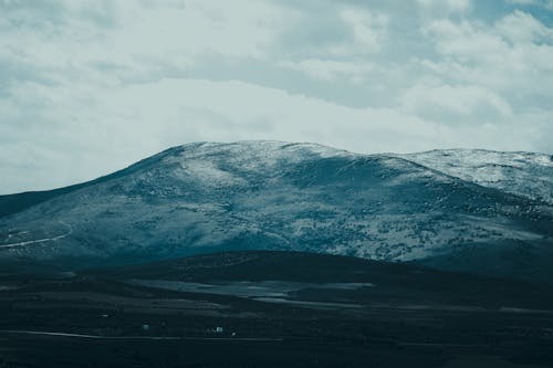 View of a Icy Hill under a Cloudy Sky 