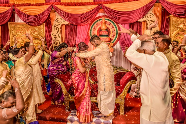 Guests Throwing Rice During A Wedding Ceremony