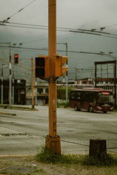 A street intersection in Mérida, Venezuela with a focus on a traffic light and bus.