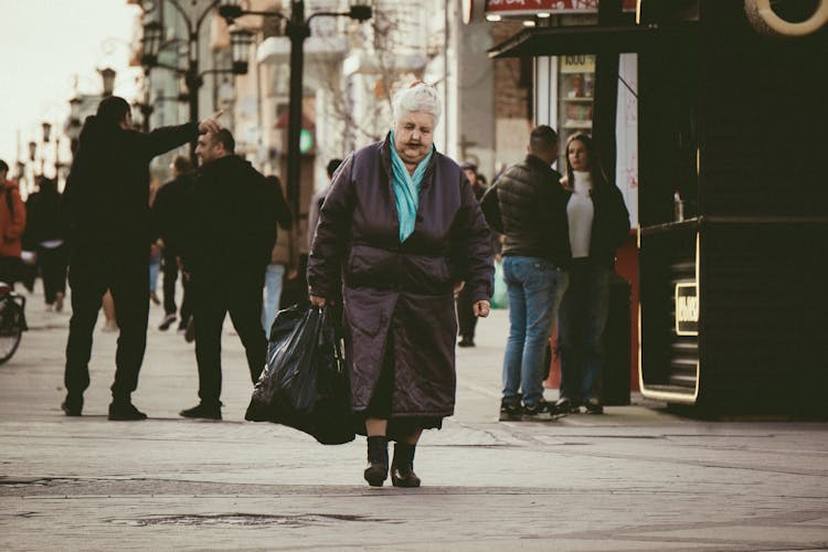 Woman In Jacket Carrying Bag