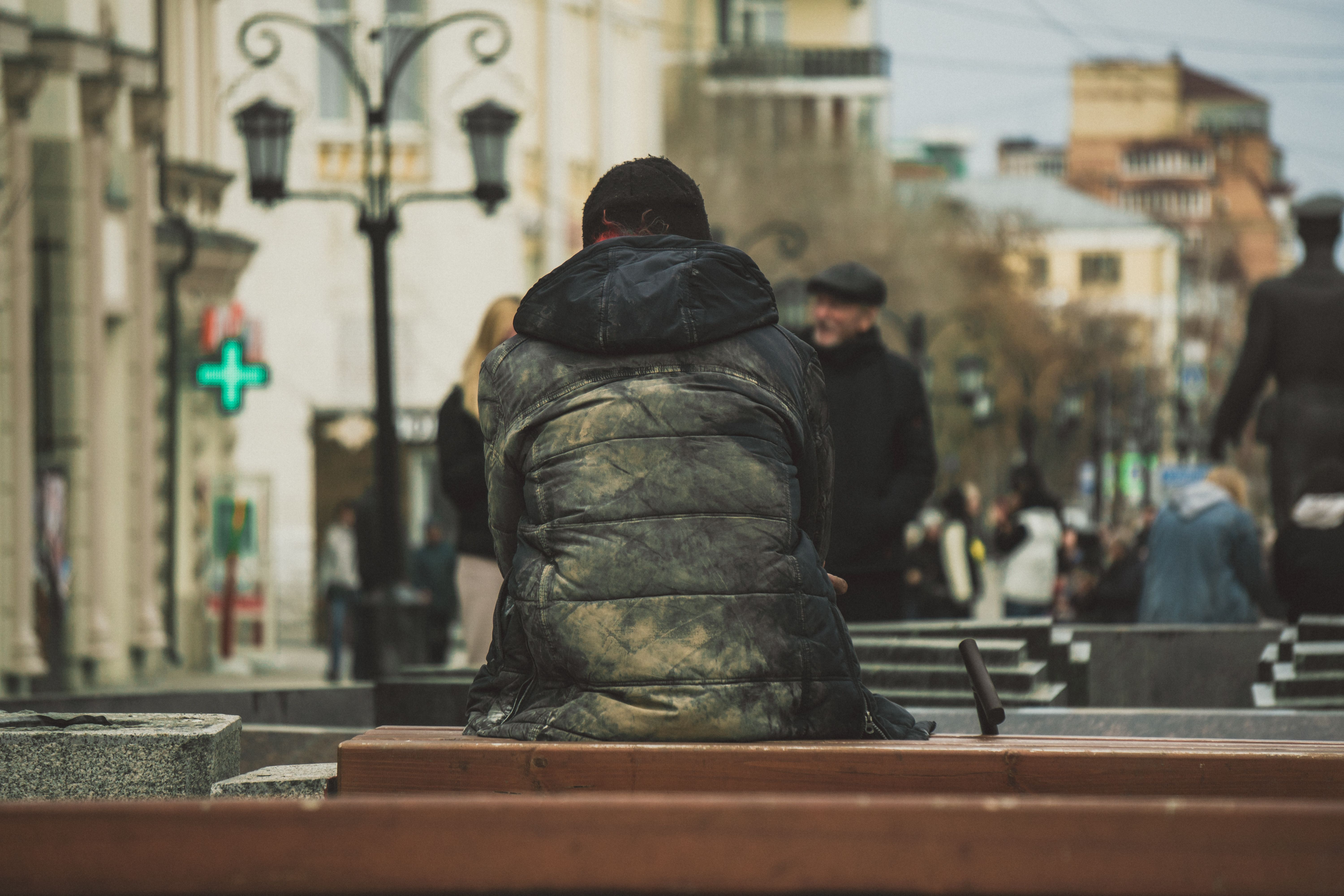 Person Sitting on a City Bench · Free Stock Photo
