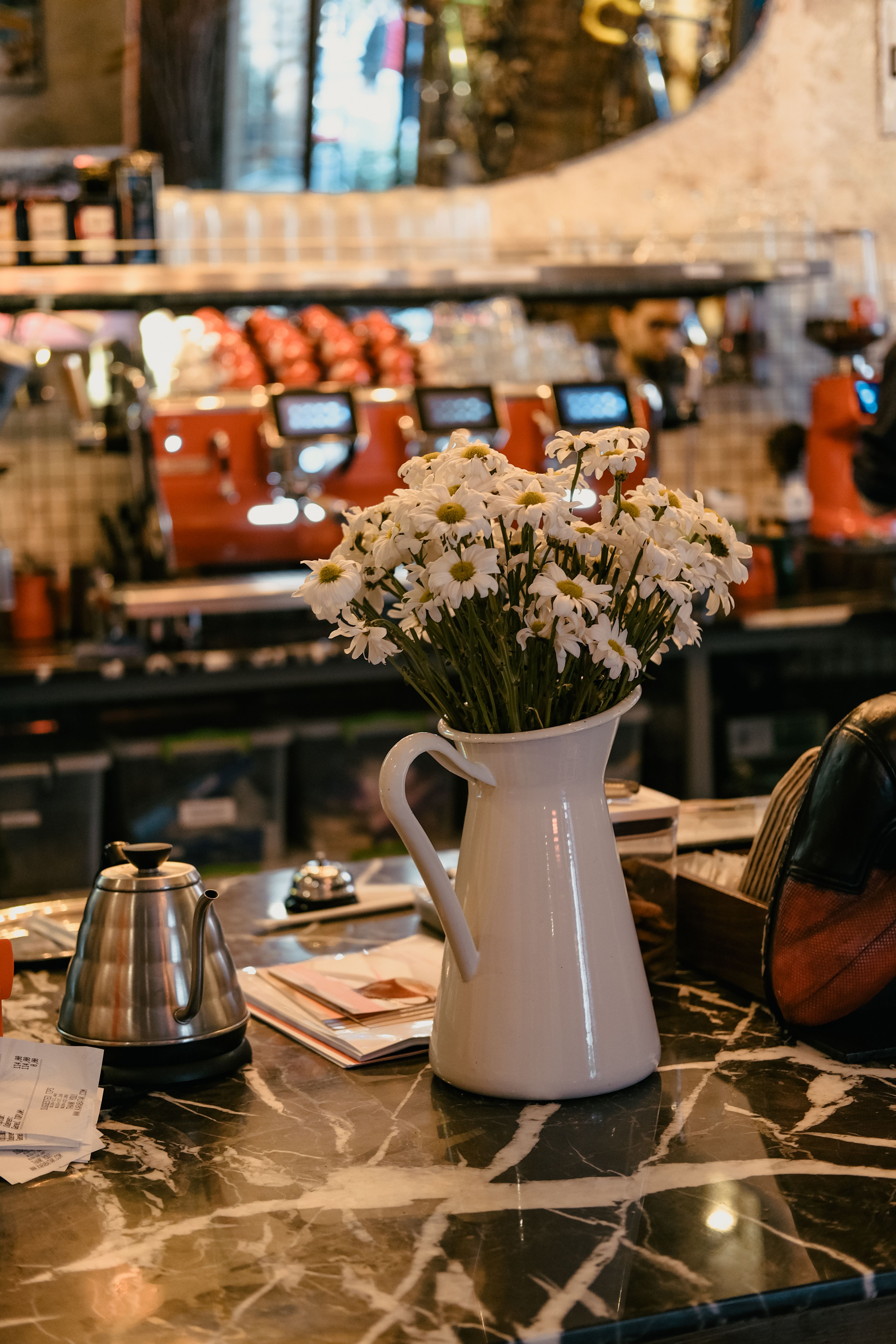 White marble accent slab placed on a coffee and tea bar counter under a pour-over set