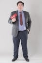 Man in a Suit Holding a Red Money Gun