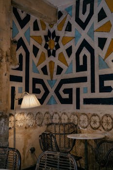 Charming café corner in Istanbul featuring intricate geometric wall patterns and cozy seating.