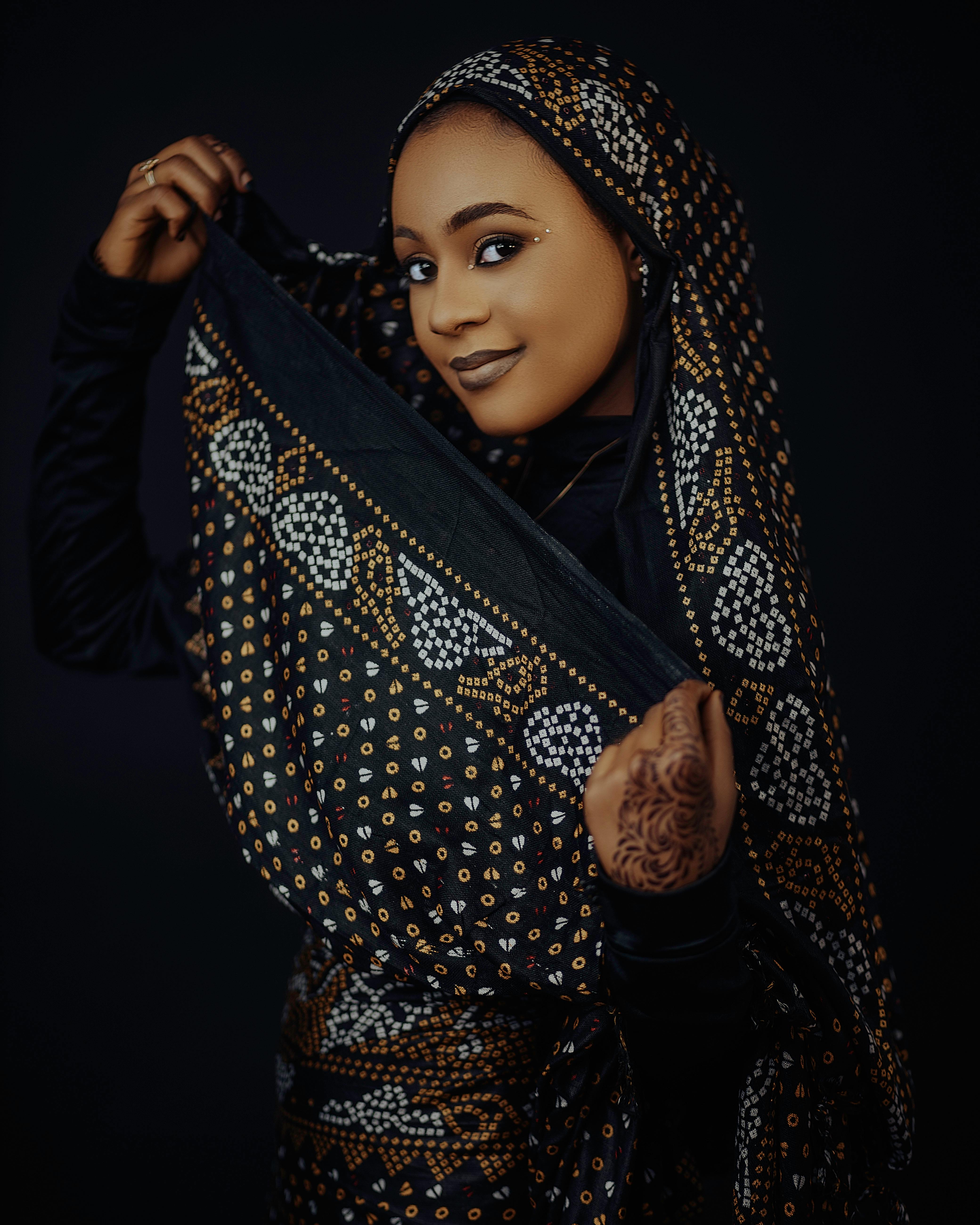 a-beautiful-young-woman-in-a-black-and-gold-outfit-free-stock-photo