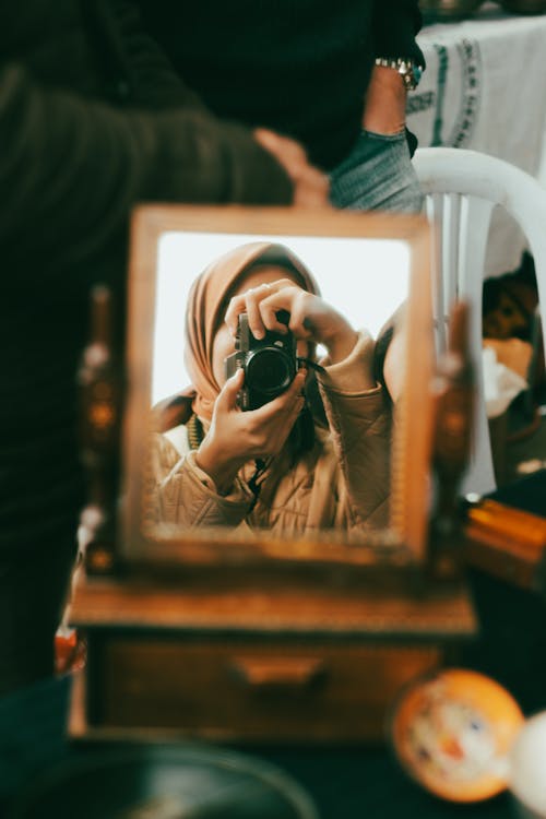 A Woman Taking a Picture in a Mirror 