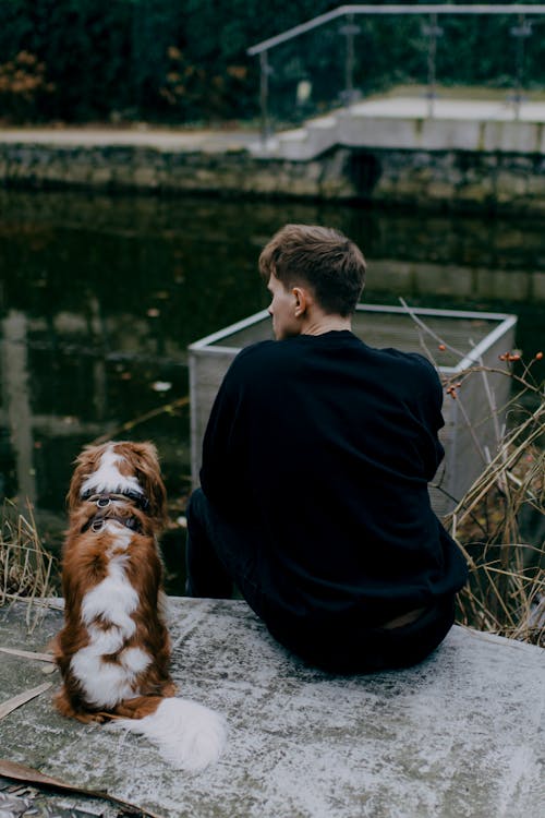 Man Sitting with Cavalier King Charles Spaniel