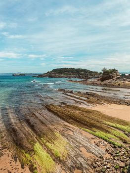 Stunning view of the rocky coast and blue sea in Santander, Spain.