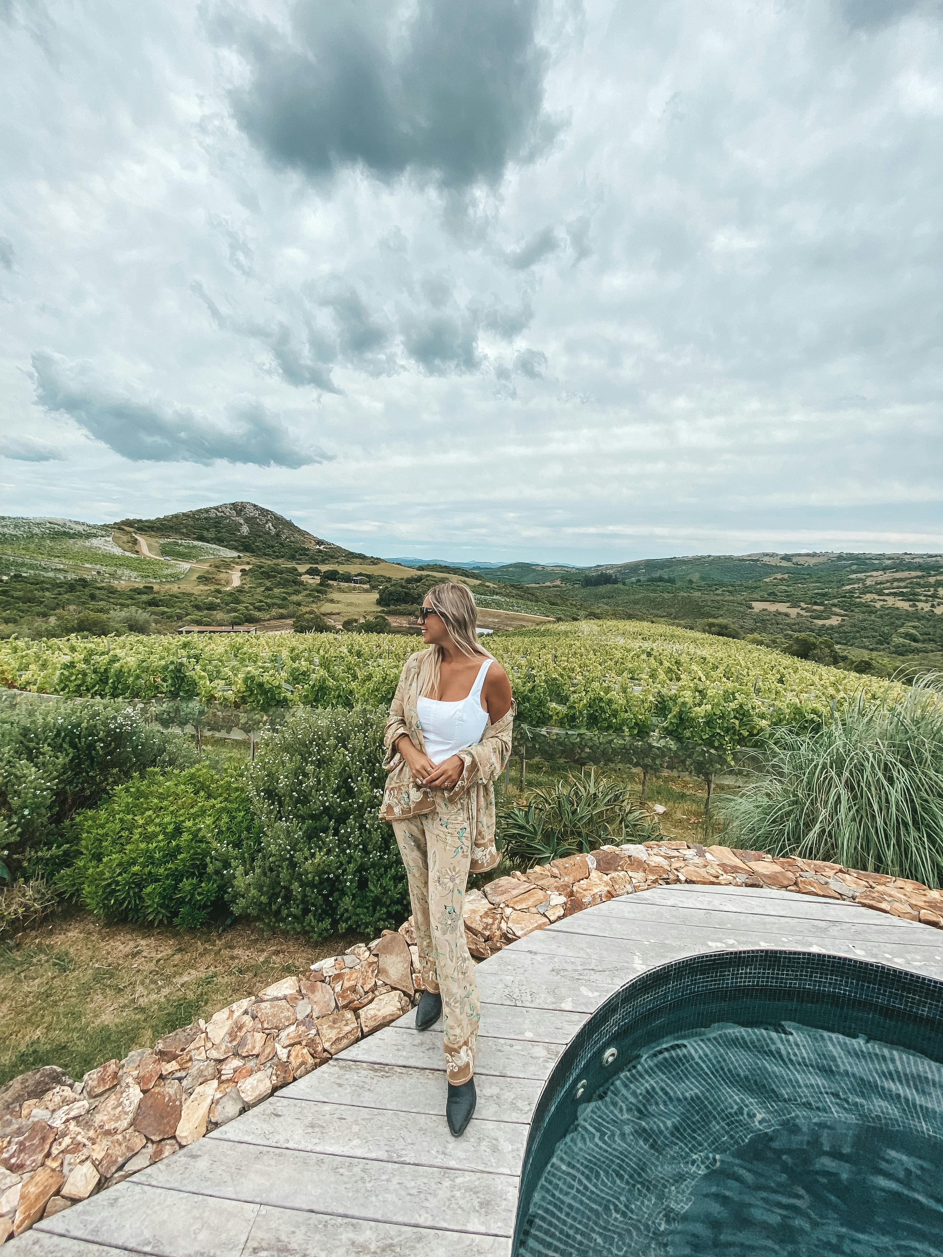 Young Woman Standing by an Outdoor Hot Tub with a Plantation in the  Background · Free Stock Photo