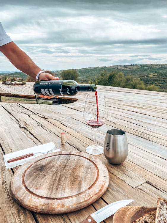 Free A Person Pouring Wine into a Glass Stock Photo