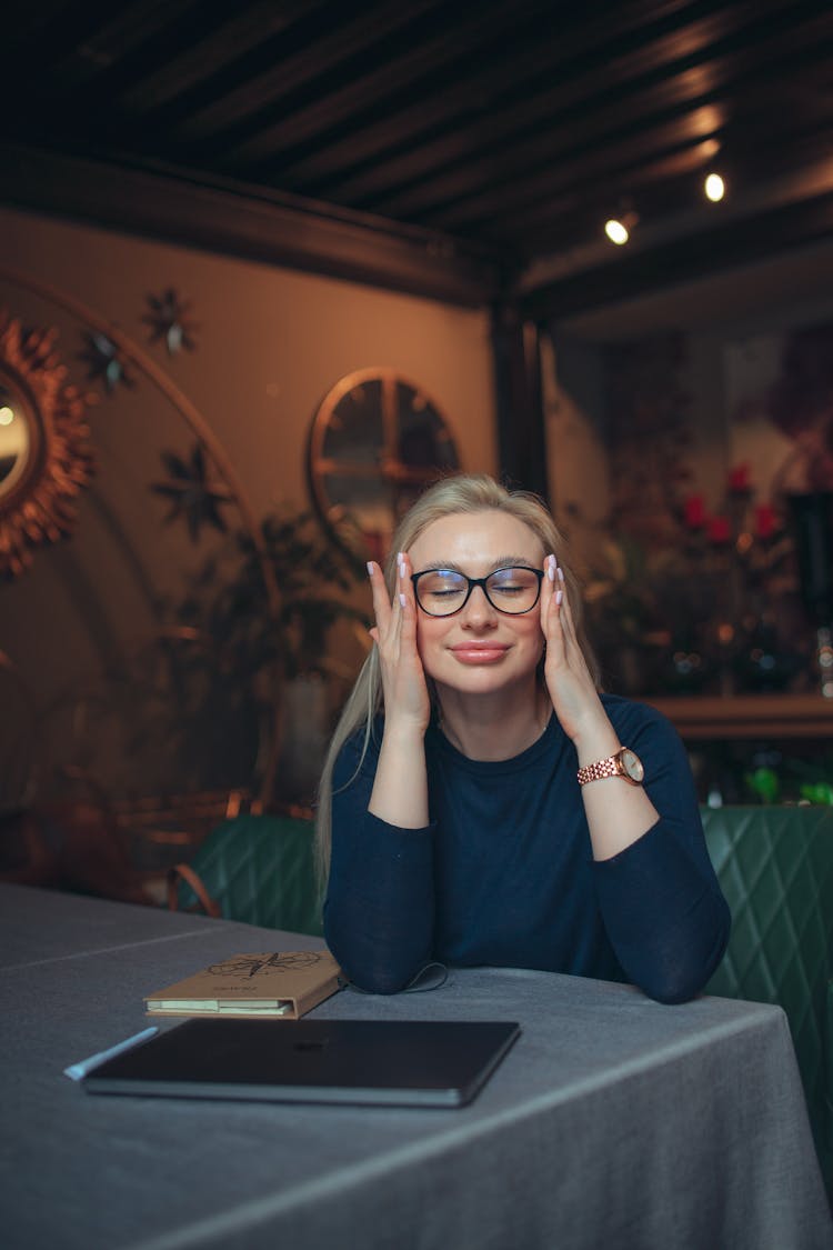 Smiling Woman Adjusting Her Glasses