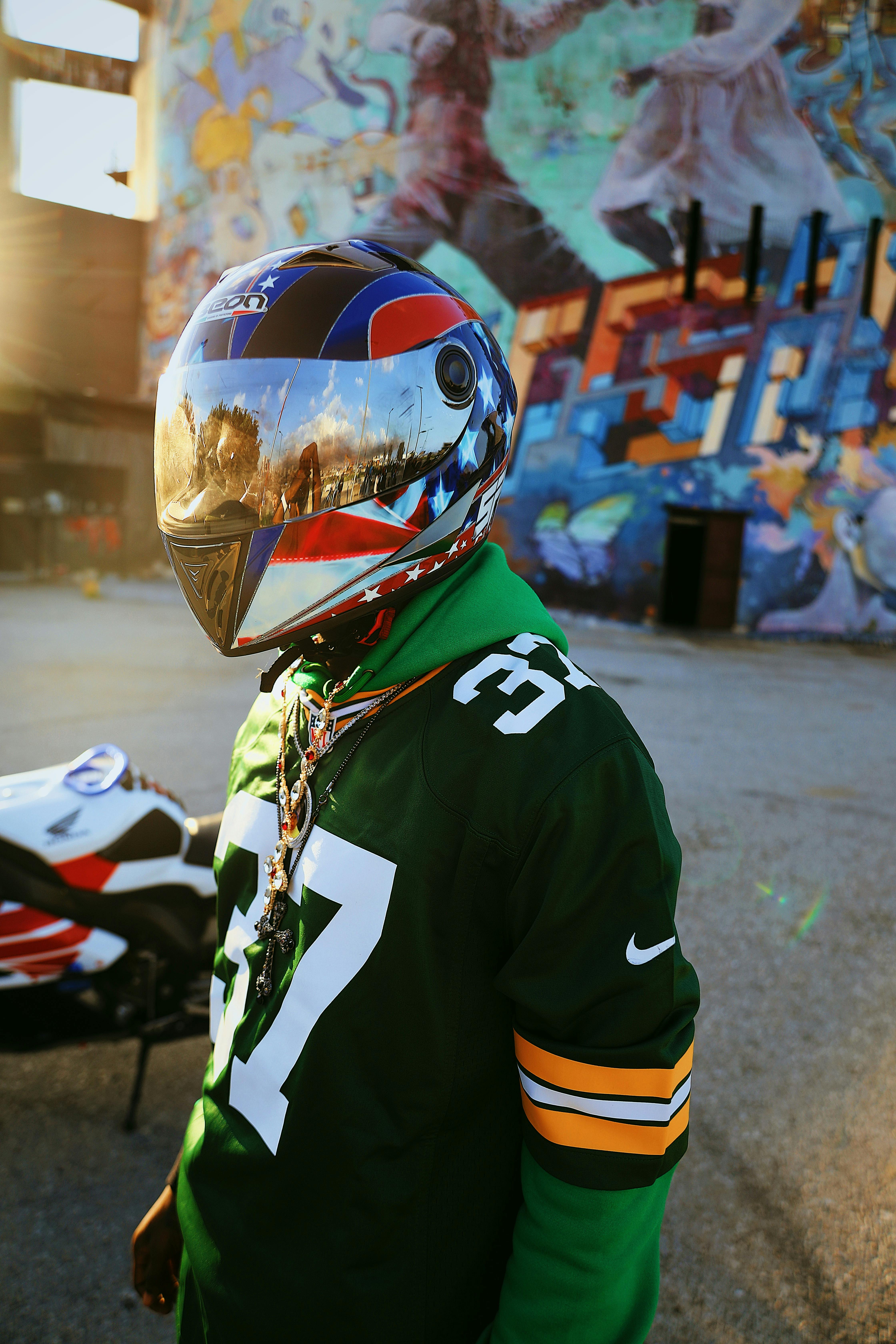 Free Man Standing in Bike Helmet by Motorcycle Stock Photo