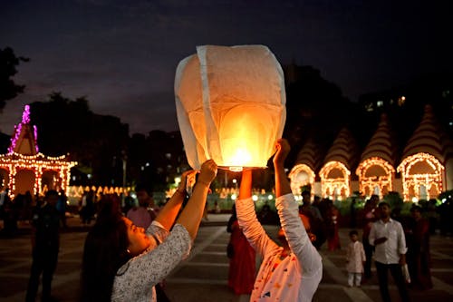Free Couple Releasing Flaming Paper Lantern Stock Photo