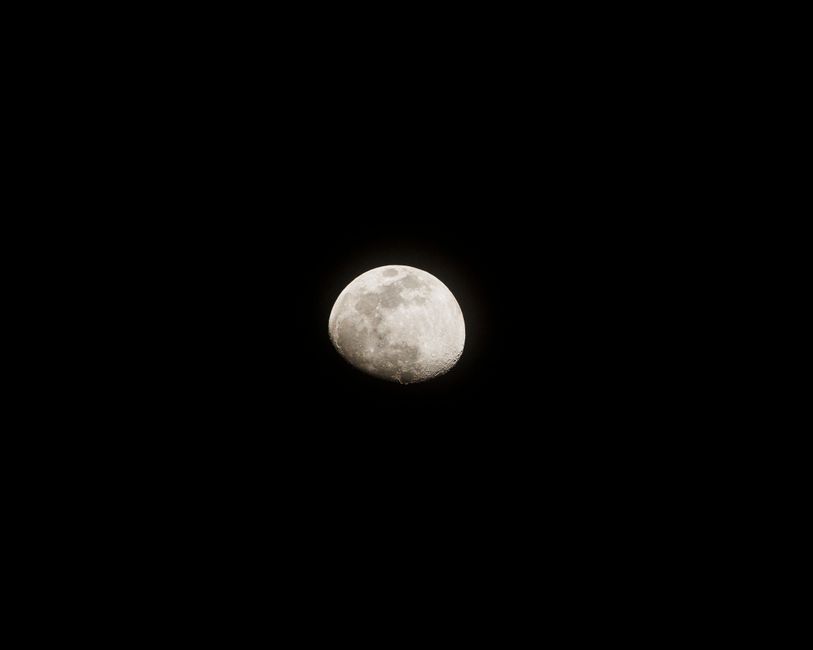 High-resolution photograph of the moon against a clear night sky, showcasing lunar details.
