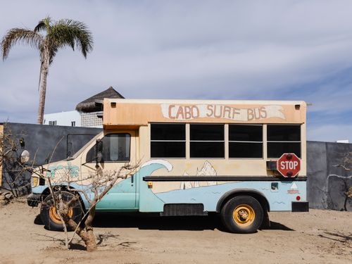 Free A colorful surf-themed bus parked outdoors in El Pescadero, Mexico. Stock Photo