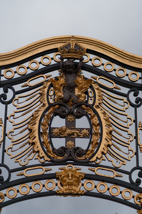Free Close-up of a gold and wrought iron decorative gate with royal crest in London. Stock Photo