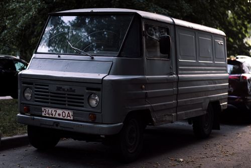 Free A gray vintage truck, model Zuk, parked outdoors among trees. Stock Photo