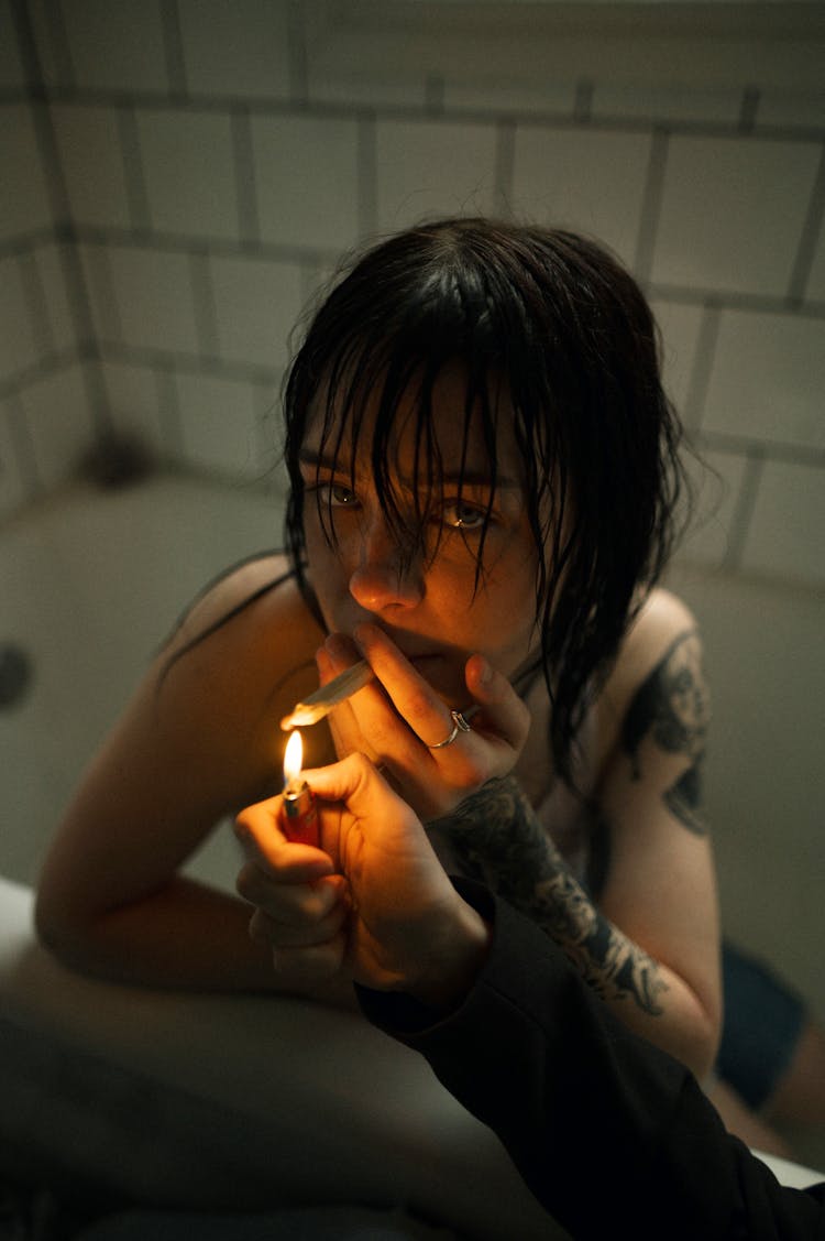 Girl With Tattoos Smoking Cigarette In Bath