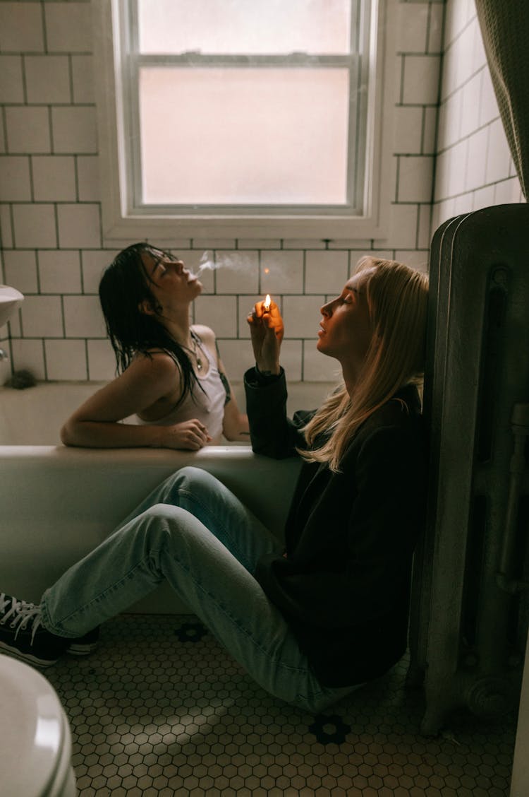 Girls Sitting In Bath Smoking Cigarettes