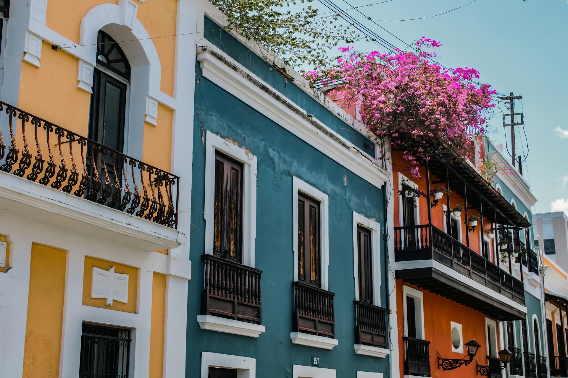 Colorful colonial architecture in Old San Juan, Puerto Rico showcases vibrant facades and floral decor.
